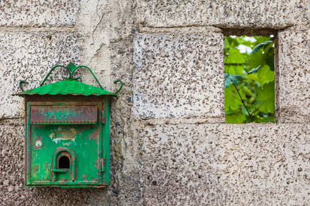 Old green mailbox on concrete wall, Tenerife, Canary Islands, Spainの写真素材