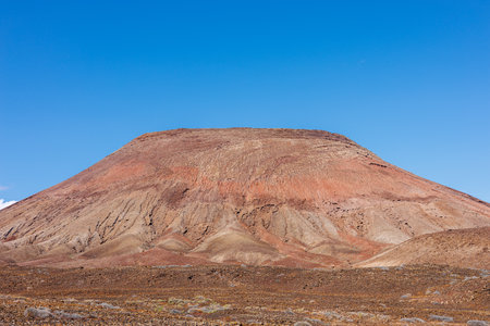 Volcanic hills complete the typical landscape of Fuerteventura in the Canary Islandsの写真素材