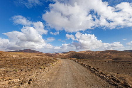 Gravel road in the mountains in the west of the island of Fuerteventura in the Canary Islandsの写真素材