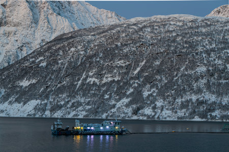 Fishing boat in the Gratangen fjord in the early evening light of the beginning of winter, Lofoten,...