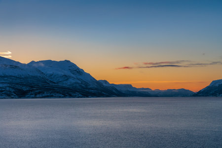 The magical light of the ending polar day on the snowy hills of Lofoten, northern Norwayの写真素材