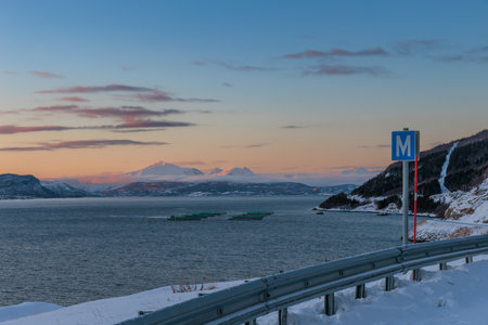 The magical light of the ending polar day on the snowy hills of Lofoten, northern Norway