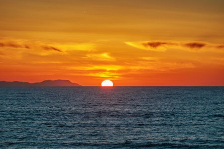 Sunset over the Ionian Sea near the town of Acharavi on the island of Corfu, Greeceの写真素材