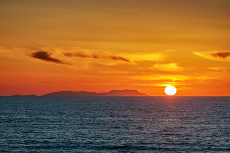 Sunset over the Ionian Sea near the town of Acharavi on the island of Corfu, Greeceの写真素材