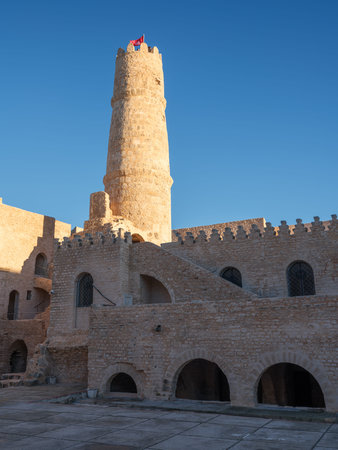 The majestic Ribat of Monastir stands under a brilliant winter sun. Home to a museum of Islamic art, this ancient stone fortress features grand walls and towers that overlook the Mediterranean, showcasing Tunisia's rich medieval heritage.の写真素材