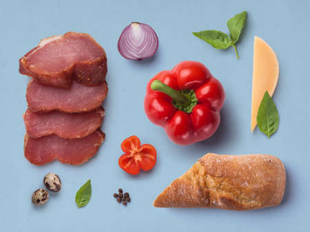 ingredients vegetables and meat on a blue backgroundの写真素材