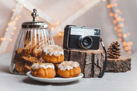 objects on sackcloth bank and cookies with nuts and chocolate cake with a camera