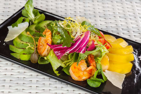 mango and prawn salad on a light backgroundの写真素材