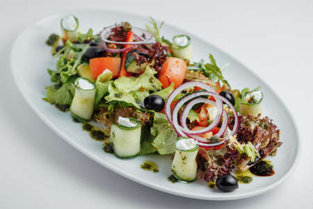 salad with onions, tomatoes, cucumbers and olivesの写真素材