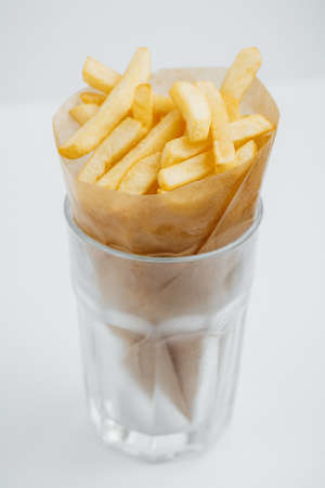 French fries in a cone food kraft paper in a glass