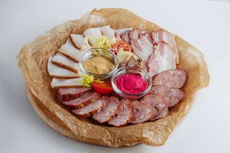 Meat and smoked bacon with sauce on food kraft paperの写真素材