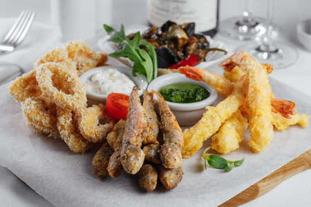 squid rings, fish, mussels, shrimp with tomato closeupの写真素材