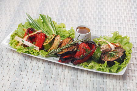 Vegetarian food - barbecued vegetables on a rectangular plateの写真素材