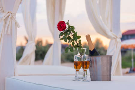 glasses of wine on a background of rosesの写真素材
