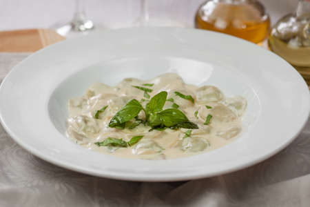 meat dumplings with basil on a plateの写真素材