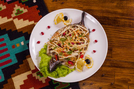 Stuffed fish with cheese, lemon and greens.の写真素材