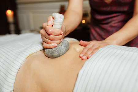 Thai massage with a compress with healing herbsの写真素材