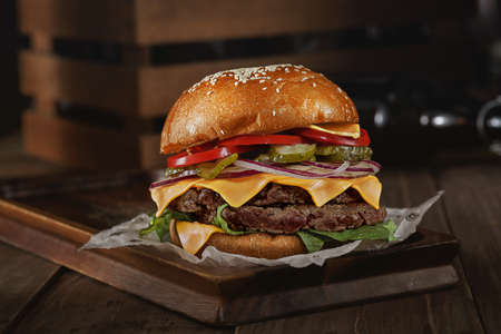 tasty hamburger on a wooden table with meat and herbs for a menuの写真素材