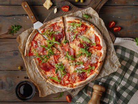 Delicious italian pizza served on wooden tableの写真素材
