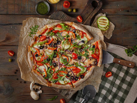 Delicious italian pizza served on wooden tableの写真素材