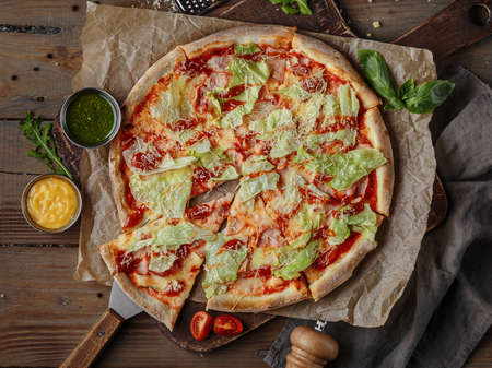 Delicious italian pizza served on wooden tableの写真素材