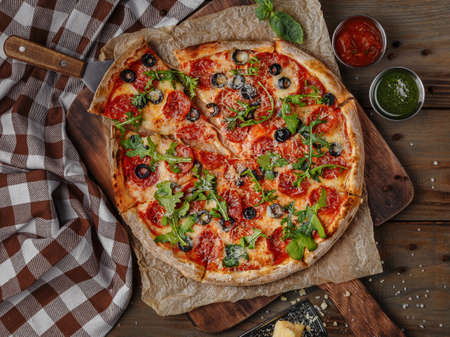 Delicious italian pizza served on wooden tableの写真素材