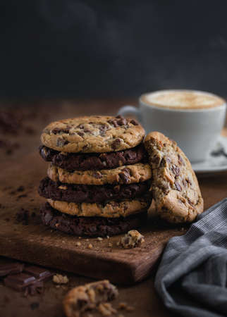 stack of chocolate and oatmeal cookies with a cup of coffee