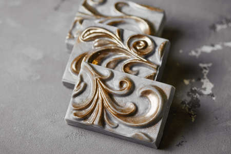 handmade soap in the form of a plaster cast with carved ornamentの写真素材