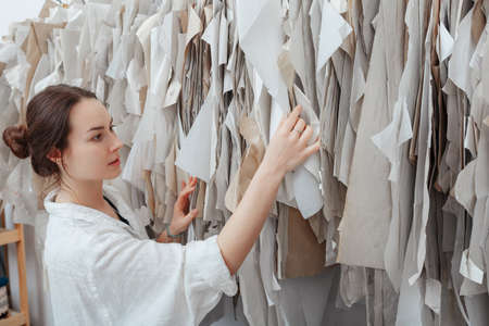 tailor chooses what pattern to work. sewing workspaceの写真素材