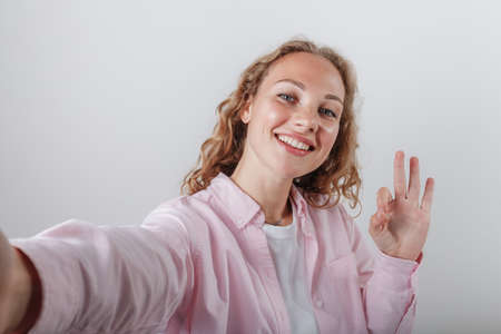 The girl shows the mark with her fingers OKの写真素材