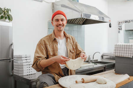 young businessman makes the dough in his cafeの写真素材