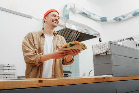 young man cooking piada on the kitchenの写真素材