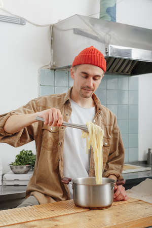 man makes handmade pasta in a his cafeの写真素材