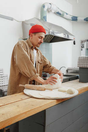 chef makes the dough for handmade pizza