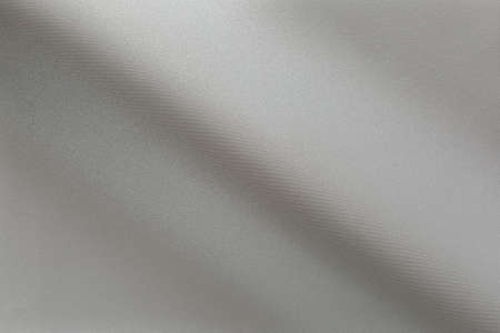 Gradient fold on shiny fabric with fine texture metallic hueの写真素材
