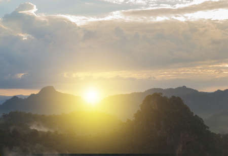 The sun rising from the mountains in the morning.