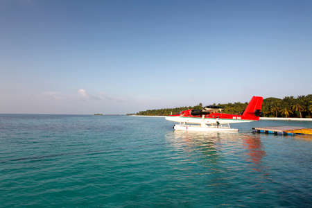 maldives beautiful day and a sea plane taxiの写真素材