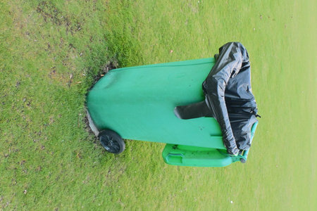 Green cart on the golf course with green grass background, top viewの写真素材