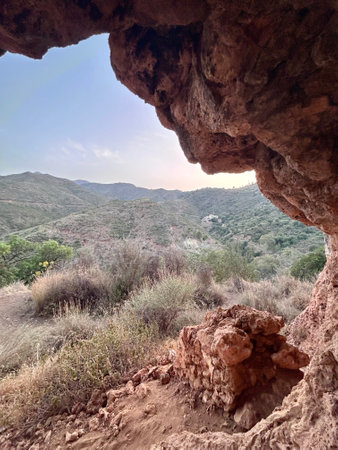 A view from inside of a cave in the mountains