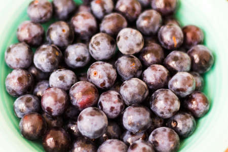 ripe plum on a plate close-up