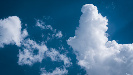 Blue sky with white clouds creating different shapes and moods.