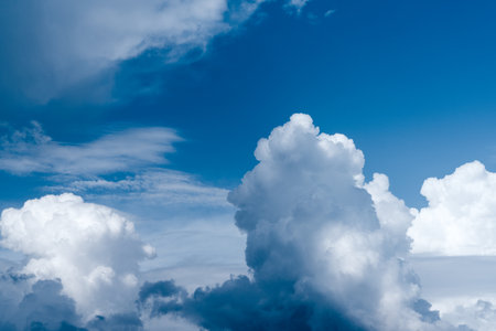 Blue sky with white clouds creating different shapes and moods.