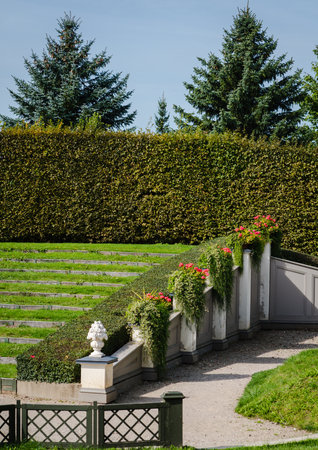 Part of a park with a stepped empty terrace and flower pot decorations along the edge. Selective focus.の写真素材