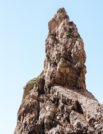 Capri, Italy - 04.29.2025: Pointed mountain peak against a light blue sky. Low angle view.の写真素材