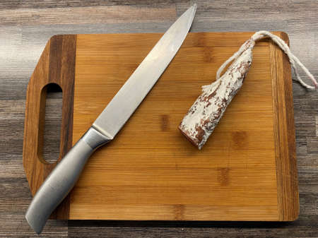 Italian dried sausage on a wooden table.の写真素材