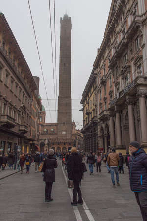 Italy, Bologna - November 19 2016: the view the people on the street and Asinelli tower 97 m in the fog on November 19 2016 in Bologna, Emilia Romagna , Italy.のeditorial素材
