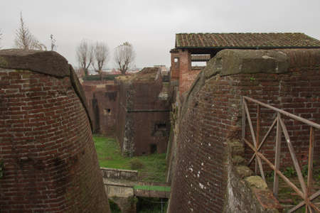 Italy, Pistoia - November 27 2016: the view of brick walls and moat around Medici Fortress of Santa...