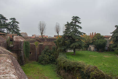Italy, Pistoia - November 27 2016: the view of brick walls and moat around Medici Fortress of Santa Barbara on November 27 2016 in Pistoia, Tuscany, Italy.のeditorial素材