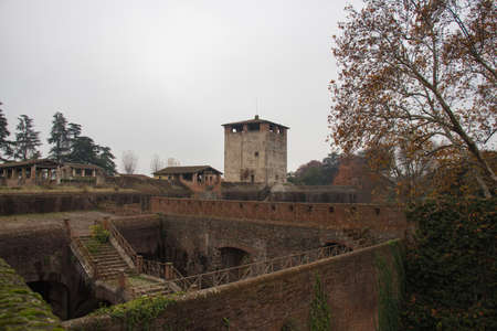 Italy, Pistoia - November 27 2016: the view of medieval tower and walls of Medici Fortress of Santa Barbara on November 27 2016 in Pistoia, Tuscany, Italy.のeditorial素材