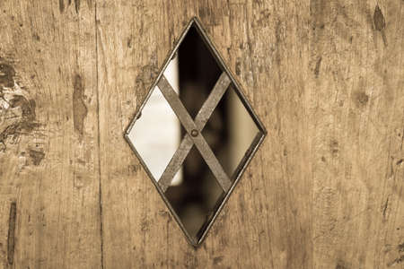 The view of a tiny window into the camera of a prison or dungeon.の写真素材